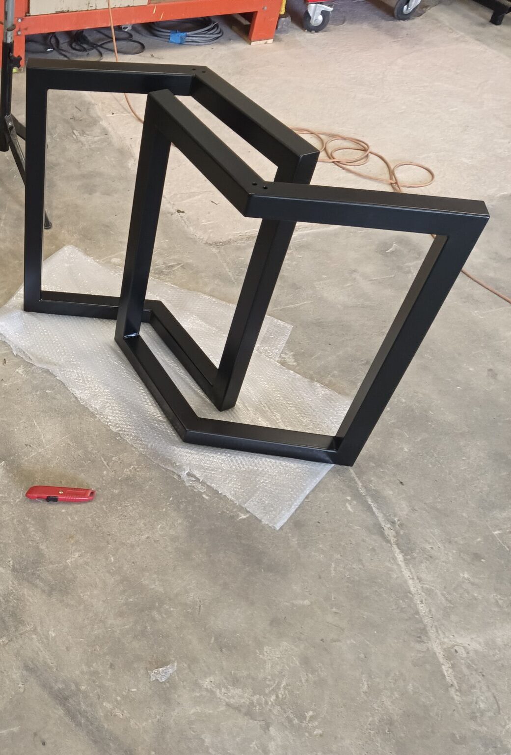 Cadres métalliques noirs sur le sol d&#039;un atelier